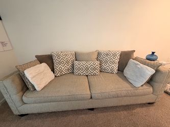 Elegant tan sofa, nailhead trim and decorative pillows