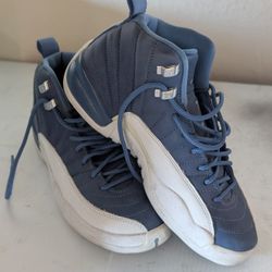 Kids Nike Air Jordan 12 Retro "Indigo" sneakers in a blue and white colorway. 