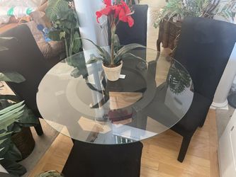 Very Nice And Clean Set Of Table With Round Glass Top And It’s Matching 4 Upholstered Black Seats With Pretty Design On Them. It’s In Great Shape.  