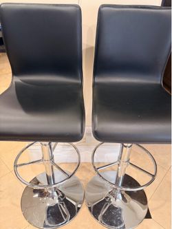 Black Faux Leather adjustable bar stools with swiveling base