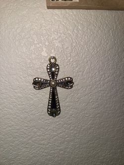 Dark blue jeweled cross with clear stones and pearl center