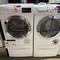 Bosch 300 Series 24" Wide 2.2 Cu. Ft. Front Load Washer and 4 Cu. Ft. Electric Dryer with SpeedPerfect® and Storage Pedestal.