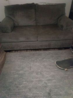 Brown couch and loveseat and coffee table and end table