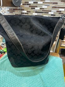 Vintage Coach canvas bucket bag shoulder bag in black with a tonal logo pattern