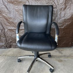 Black and chrome desk chair on wheels