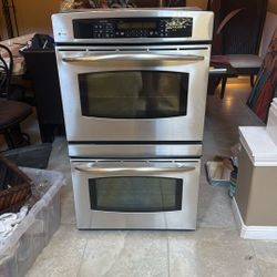  a GE Profile 30-inch built-in double electric wall oven in stainless steel with TrueTemp controls and a convection upper oven.
