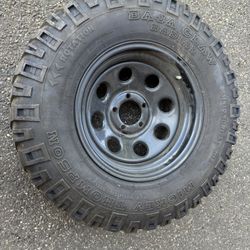 1 aftermarket 15” 5 lug jeep rim , tire is worn rim like new $50