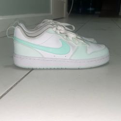  Nike Court Vision Low sneakers (low-top), in a white with mint/seafoam green colorway.