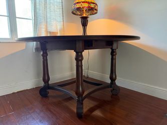 Round Dark Wood Dining Table with Turned Legs