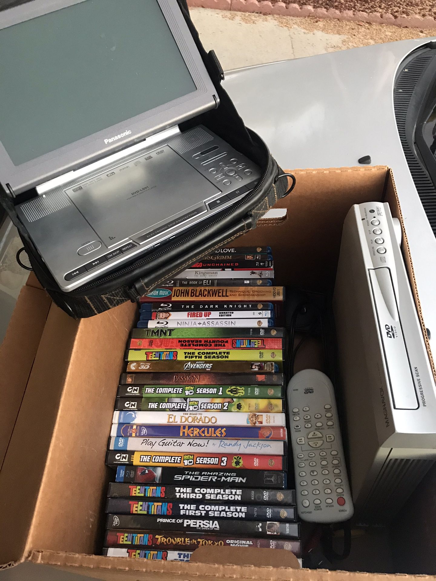 Box of DVDs & Portable player (perfect for road trips)