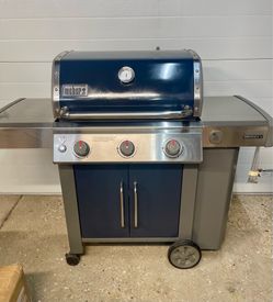 Weber gas grill with grill cover and propane tank