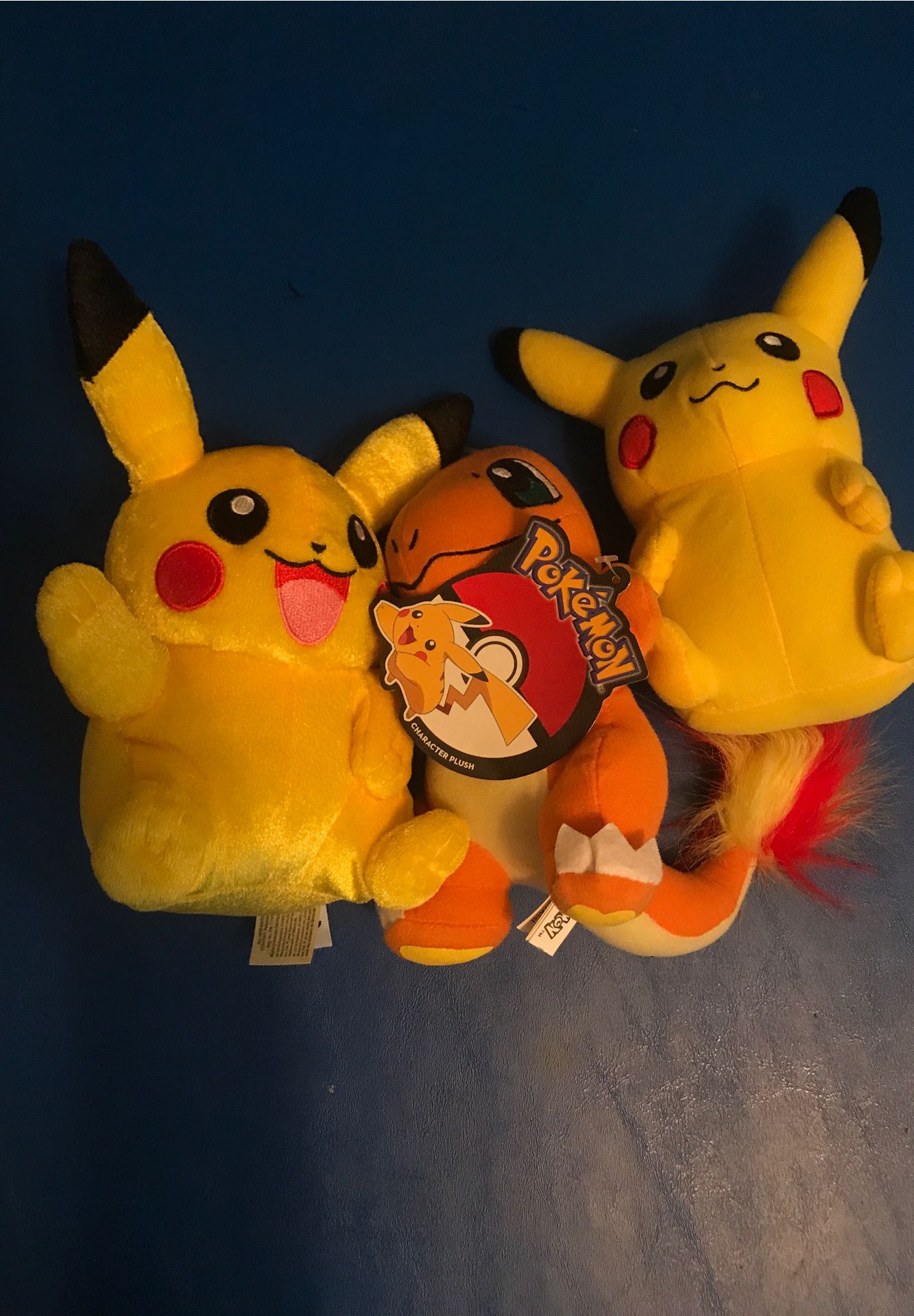 Three Pokémon stuffed animals