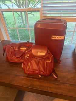DKNY three piece burgundy luggage set