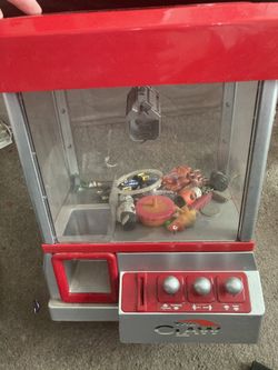 The Claw kids mini claw machine. Powered with fake or regular pennies. AA batteries included