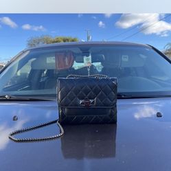 Black quilted leather crossbody bag with chain strap