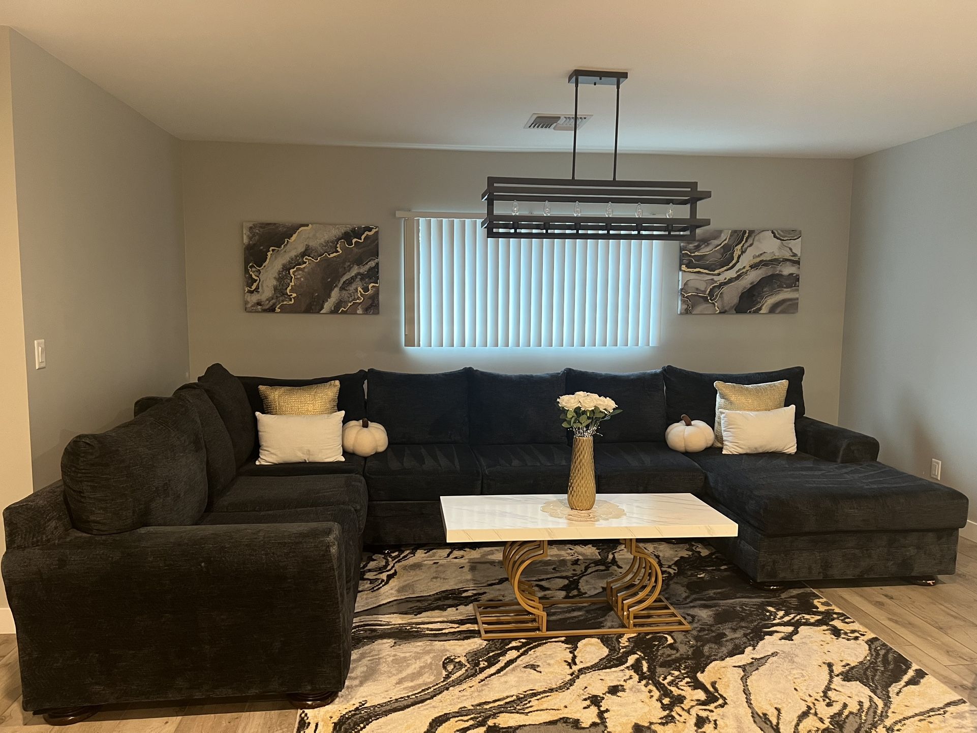 Sectional Couch, Table, Carpet, And Pictures