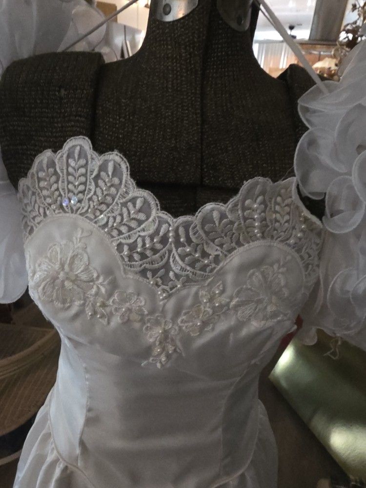 Four wedding gowns with accessories
