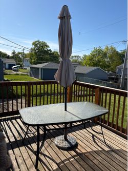 Outdoor table with umbrella and base