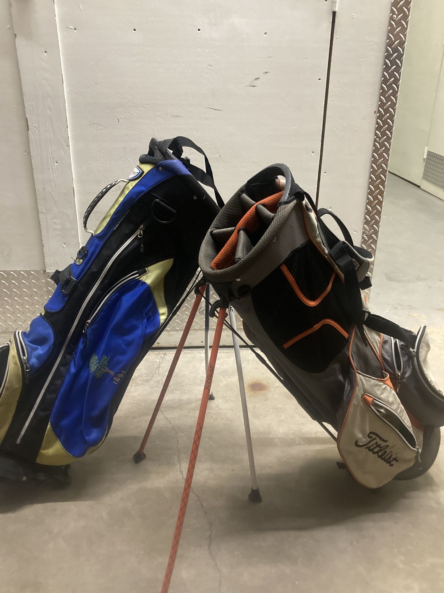 (2) TITLST GOLF BAGS.