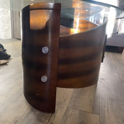 Glass top coffee table with wooden base. Stylish and sturdy. Good condition. 