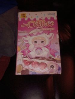 This image shows a Nommi V7 "A Bite of Sweetheart" Series collectible plush blind box  