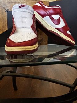 Red and white Nike Dunk High sneakers