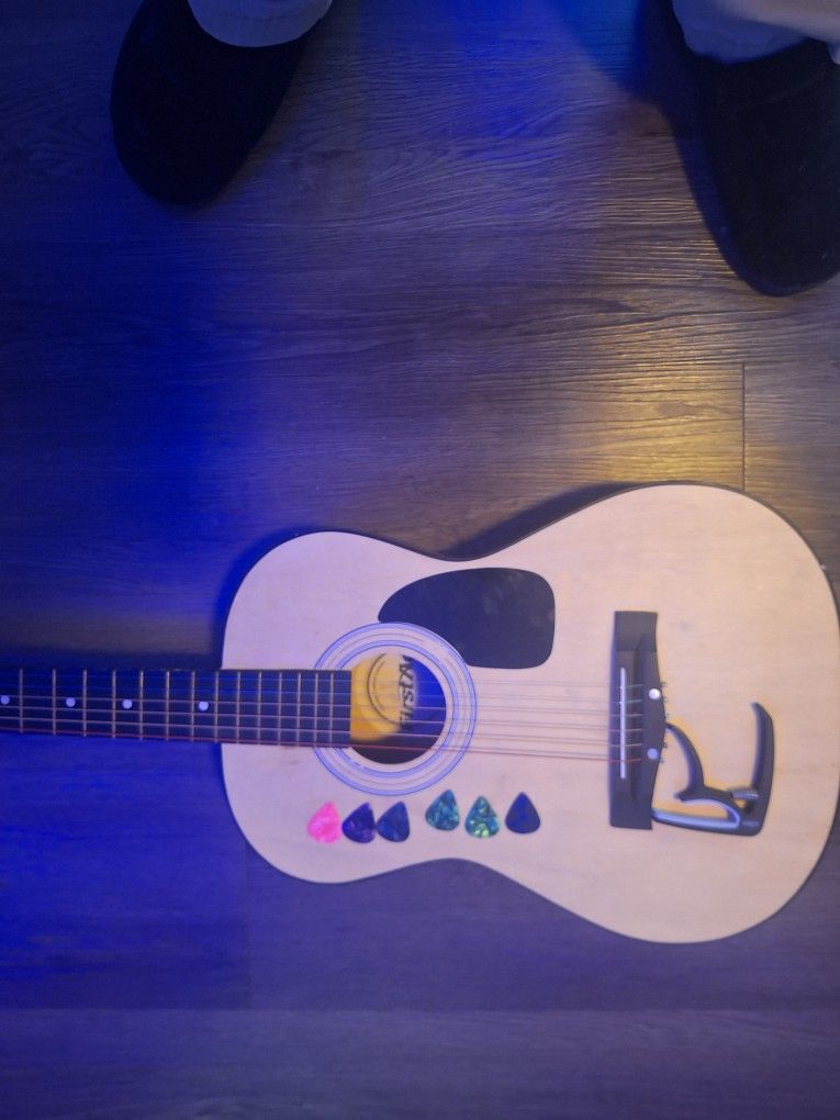 Acoustic Guitar With Picks And Capo 