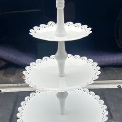 This is a white, three-tier dessert or cake stand.