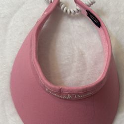 pink Ladies Twist-Cord Visor is made by Pukka Inc. and features a terry cloth headband with an adjustable cord closure.  Pink visor with white adjusta
