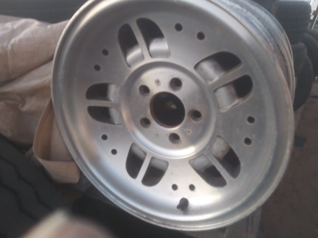 A set of rims and a bunch of tires