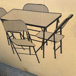 New In Box Set Of Folding Table And Four Chairs