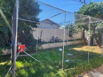 Batting cage with pitching machine
