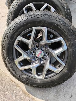 GMC Sierra and Yukon Denali 20 inch factory rims with Bridgestone Dueler tires.