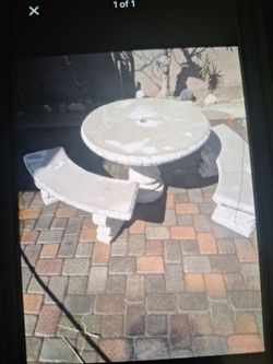 Round concrete table with matching benches