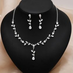 Elegant bridal jewelry set for weddings, including a necklace, earrings, and bracelet in a leaf shape, made of cubic zirconia. Perfect for a prom or g