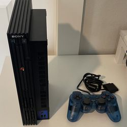 PlayStation 2 with transparent blue controller