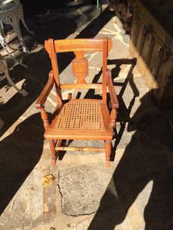 Antique child’s oak rocking chair with perfect cane seat
