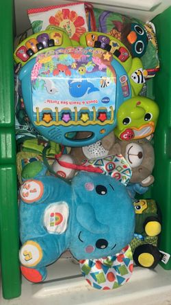 Toy box full of infant and toddler toys