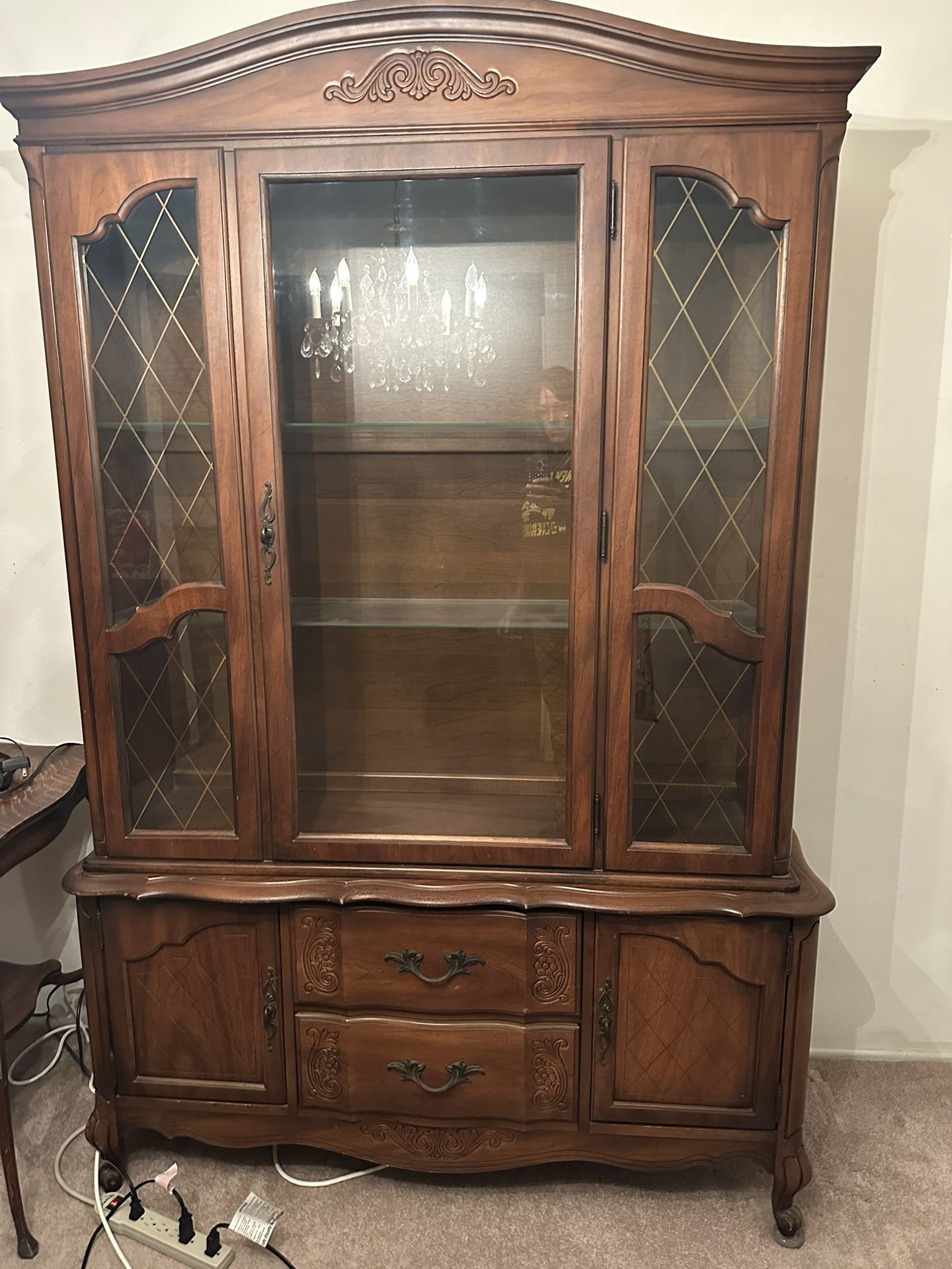 China cabinet breaks down to two parts lights up.