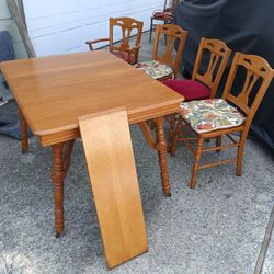 Solid wood 46"x34" kitchen table with 10" leaf & four chairs