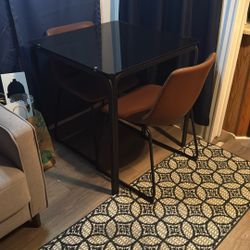 Glass Table With Two Leather Chairs