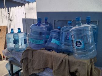 5 GAL . PLASTIC BOTTLES WITH HANDLES $5 EA