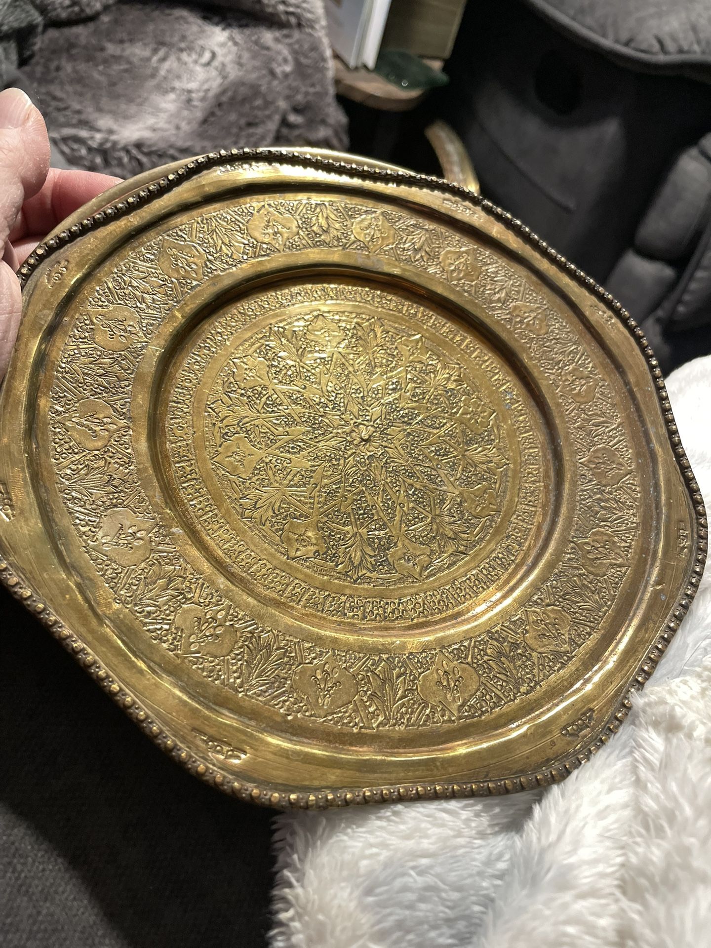 This is a vintage hand-etched brass decorative plate or tray with scalloped rim 
