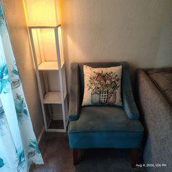 Teal Velvet Accent Chair with Wood Legs and a lamp