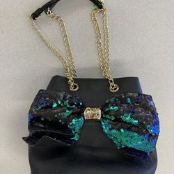 This item is a Betsey Johnson Blue Green Mermaid Bow Purse.