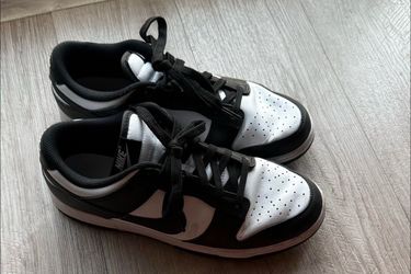 Nike Dunk Low "Panda" sneakers, recognizable by their white leather base and contrasting black overlays