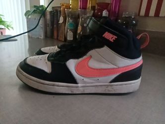 Pink and black Nike courtvisions