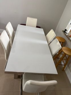 Beautiful table with 6 chairs. Chairs have tear and wear, but are beautifully covered.