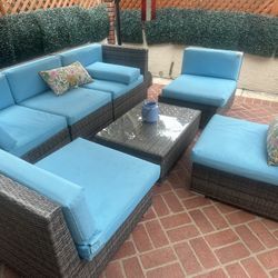 Rattan patio set and table one couch, three chairs and one center table and cushions