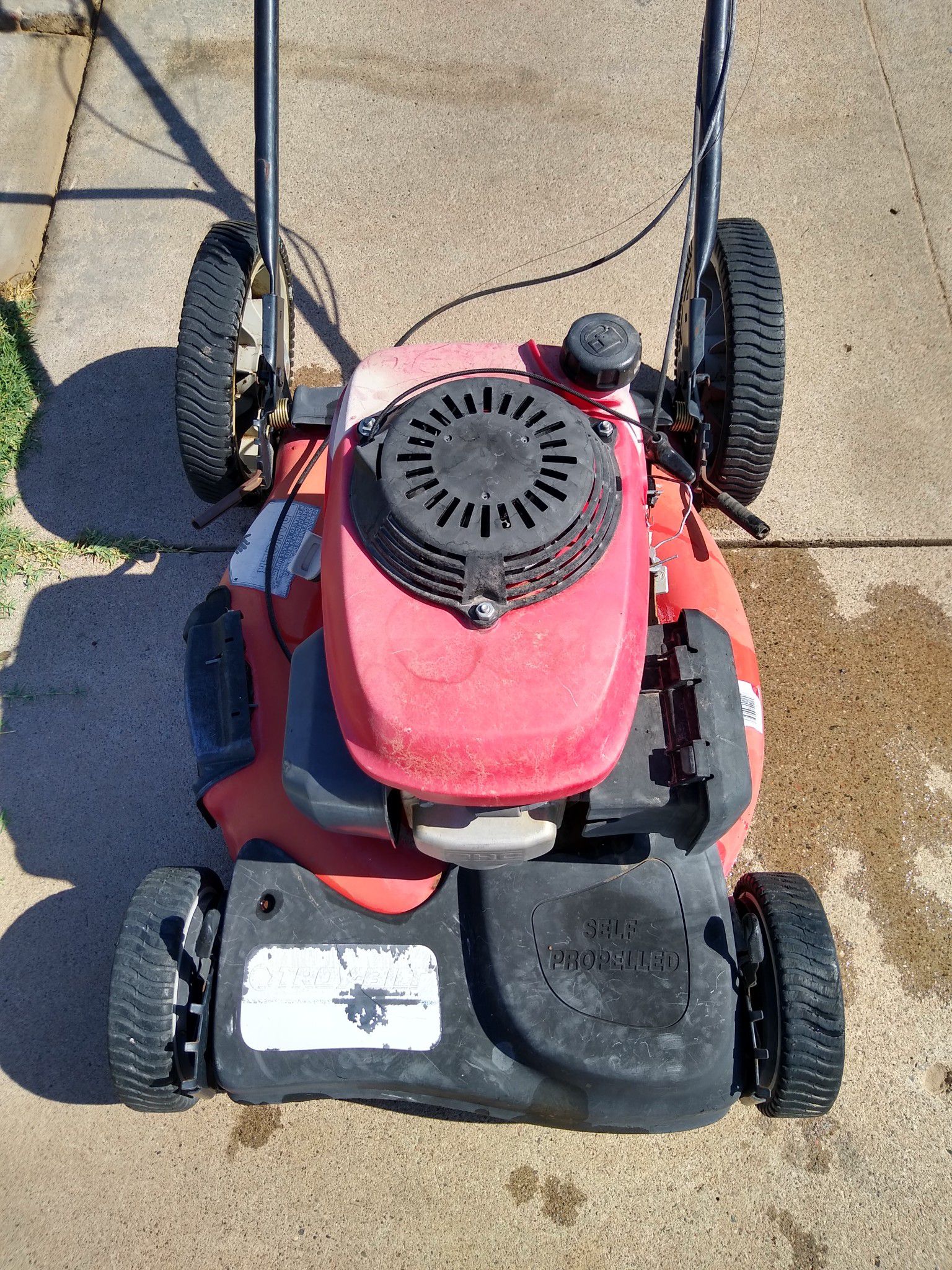 Troy-Bilt Honda powered self-propelled gas lawn mower runs great from the first pull needs some cables and a wheel as is needs work